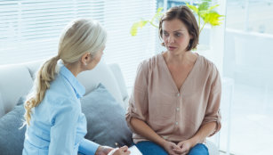 Upset woman talking to therapist