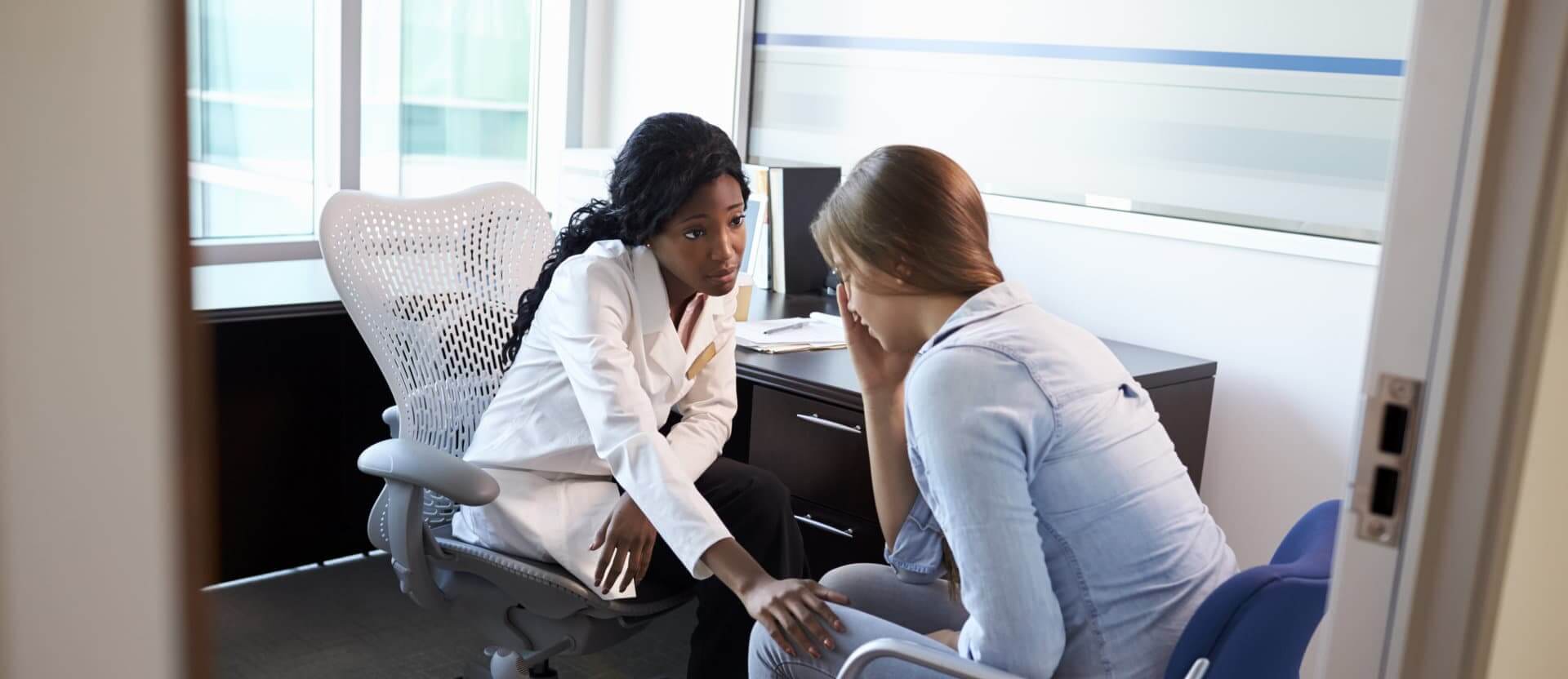 Doctor In Consultation With Depressed Female Patient