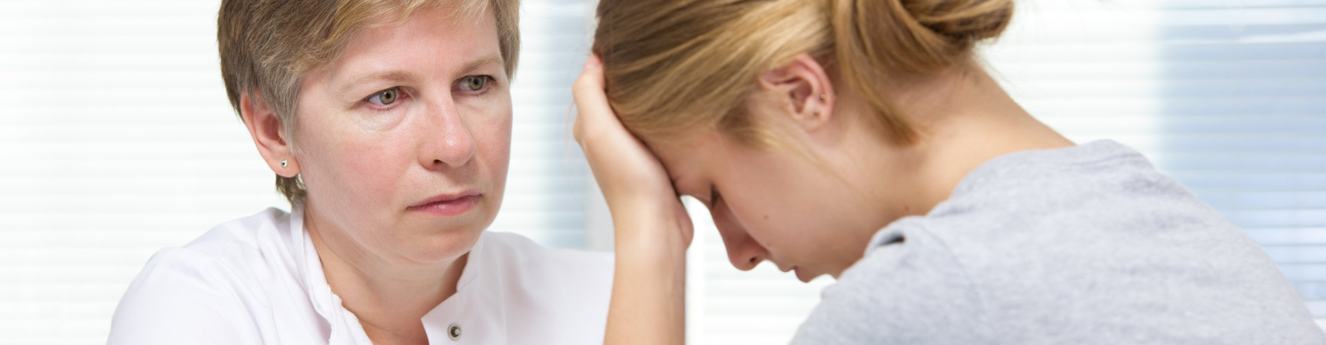 professional woman comforting a lady in distress