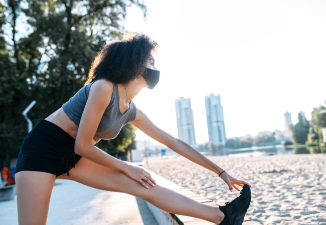 stretching legs before outdoor workout