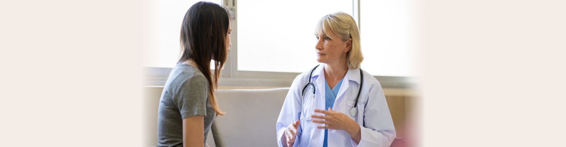 Professional psychiatrist listening to her patient in medical clinic or hospital mental health service