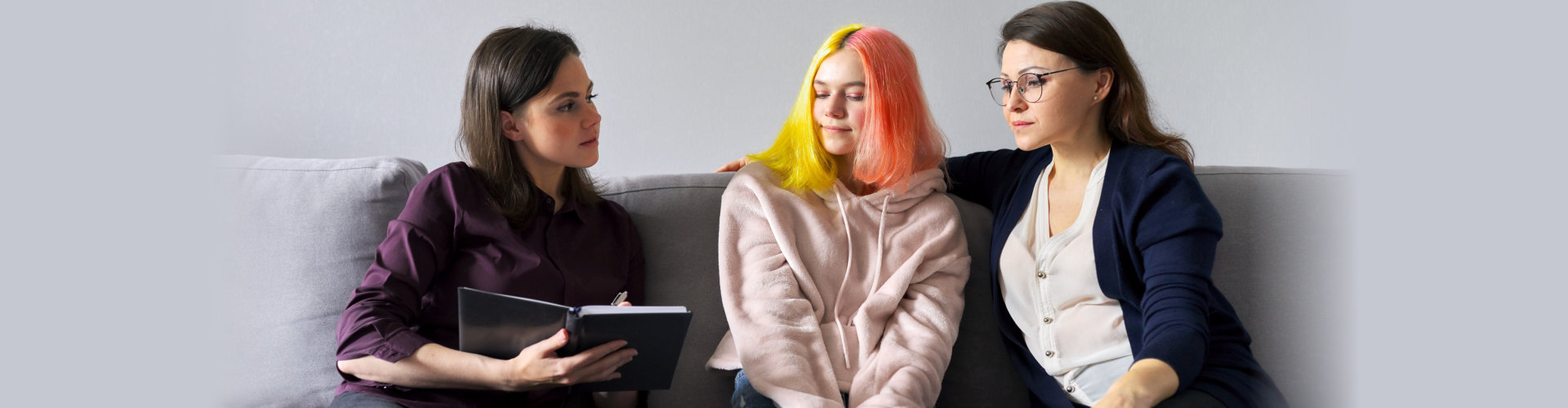 Woman talking to mother and daughter teenage girl